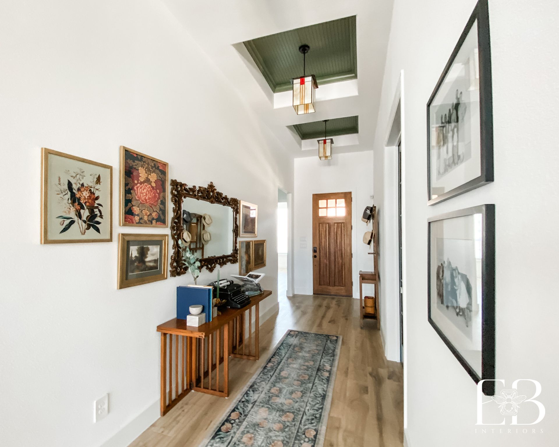 Entry vignette with green wall, vintage furniture, and mirror—Devotion Row New Construction by Emerald Bee Interiors