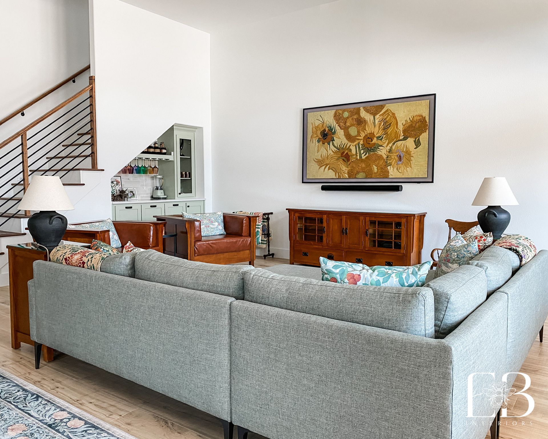 Living room with gray sectional sofa, TV, and wood furniture.