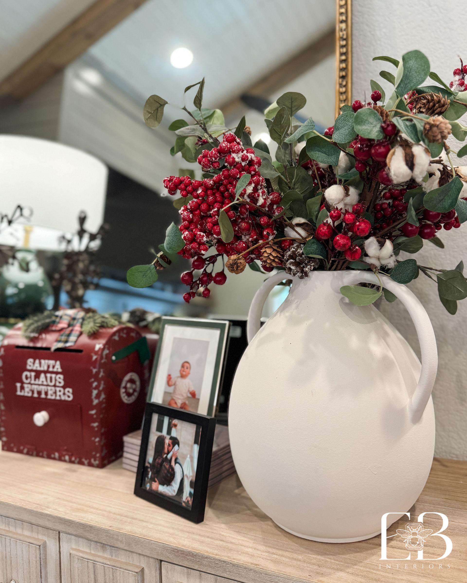 Bedroom with floral wallpaper, black doors, and a bed with white bedding and a cane headboard.