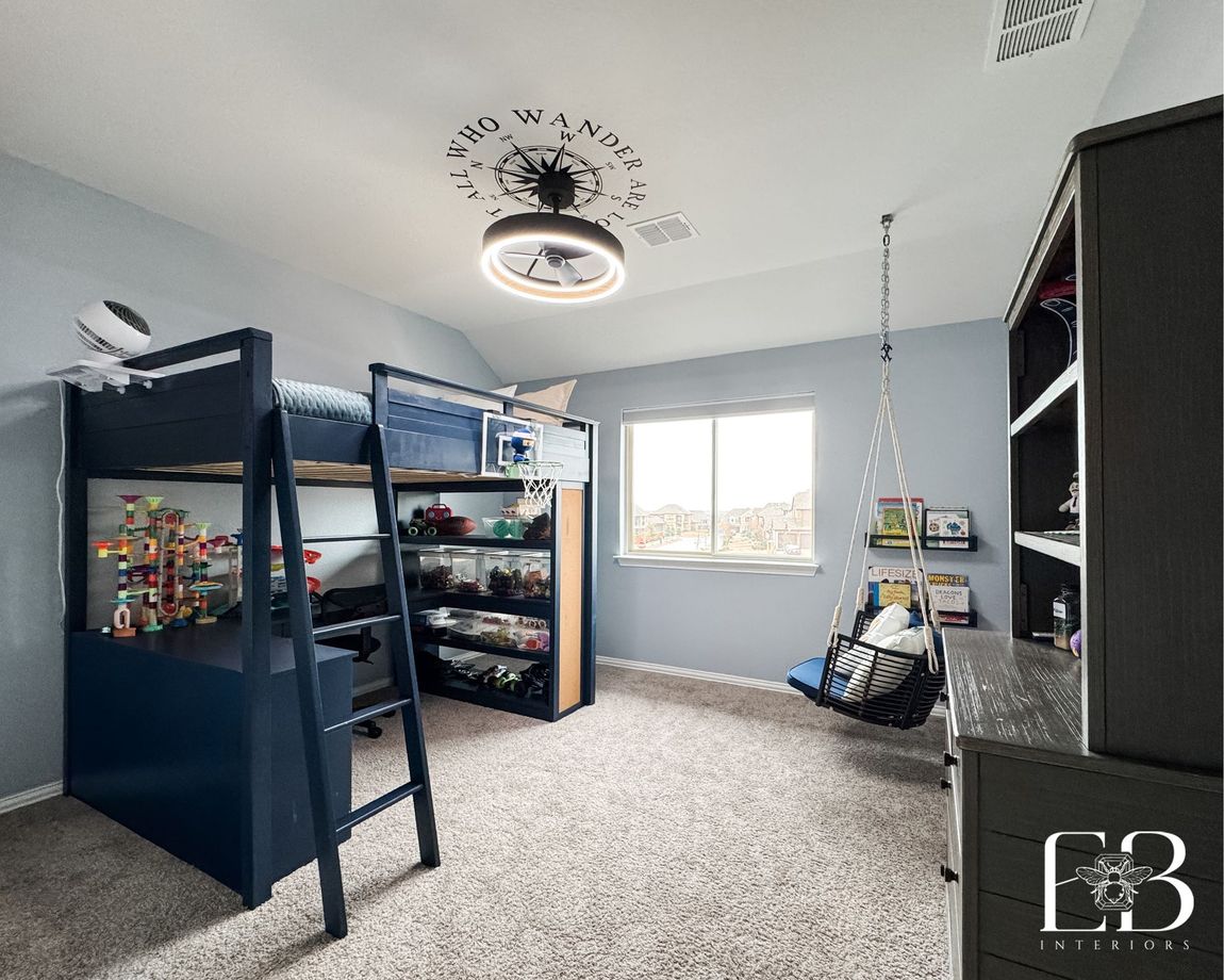 Boys’ bedroom with navy loft bed, hanging chair, and ceiling quote decal by Emerald Bee Interiors for Lantern Faith project.