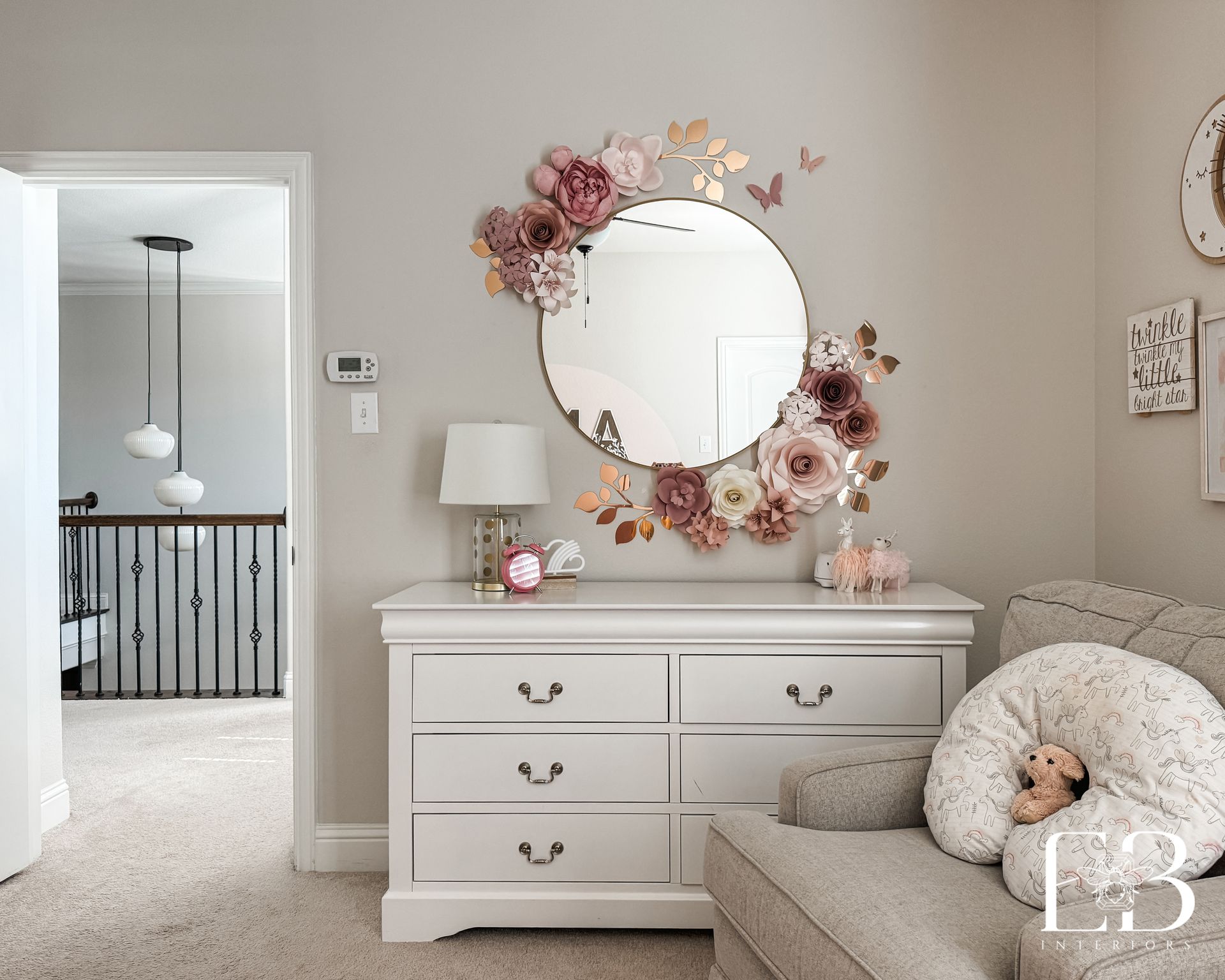 Girls' bedroom with white dresser and round mirror layered with florals by Emerald Bee Interiors for Spanish Oak Trail.