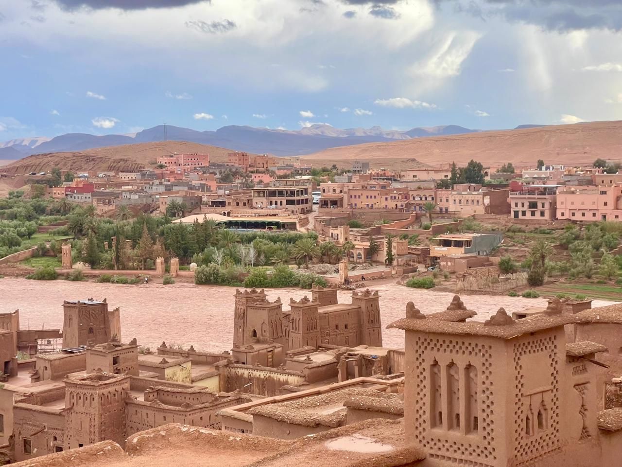 A city with a river and mountains in the background