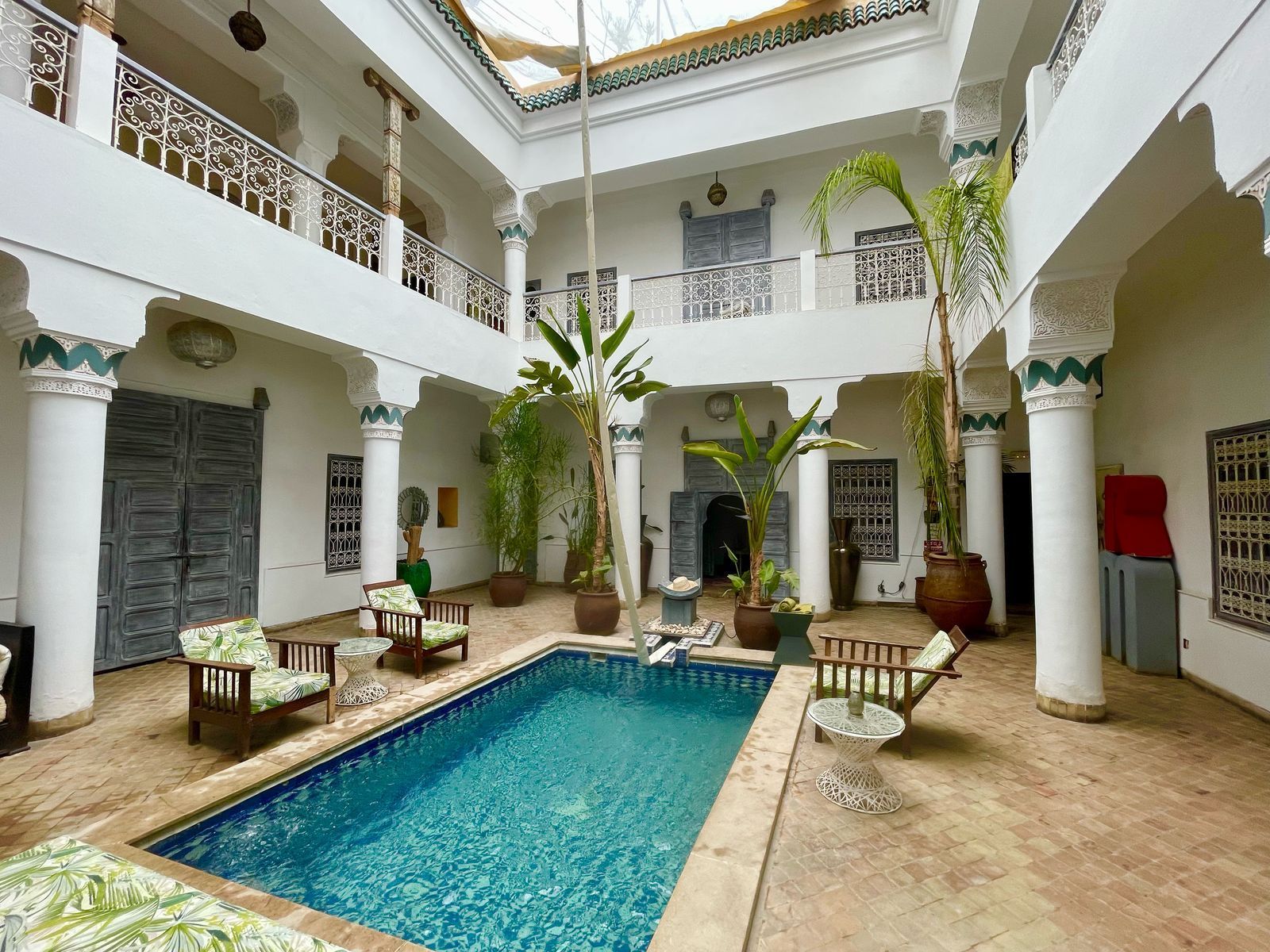 There is a large swimming pool in the middle of a building.