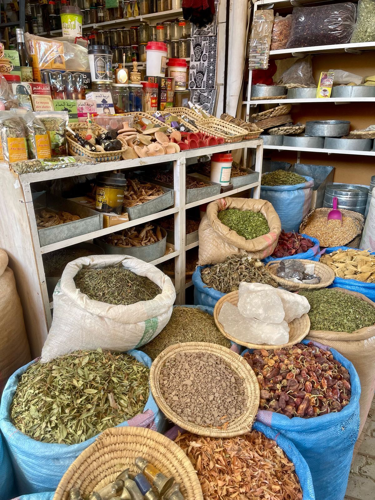 A store filled with lots of bags and baskets of spices.
