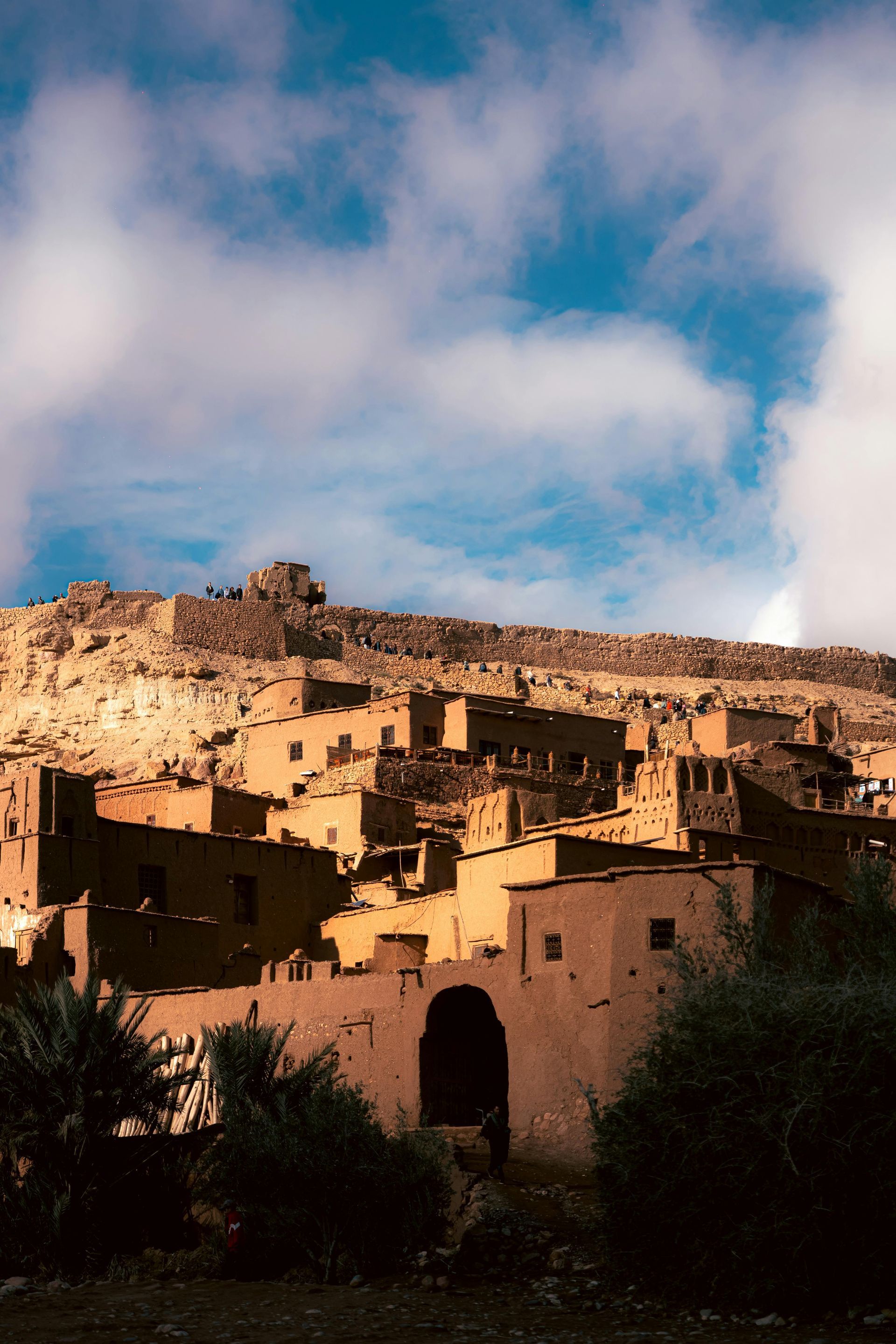 A small village on top of a hill with a blue sky in the background