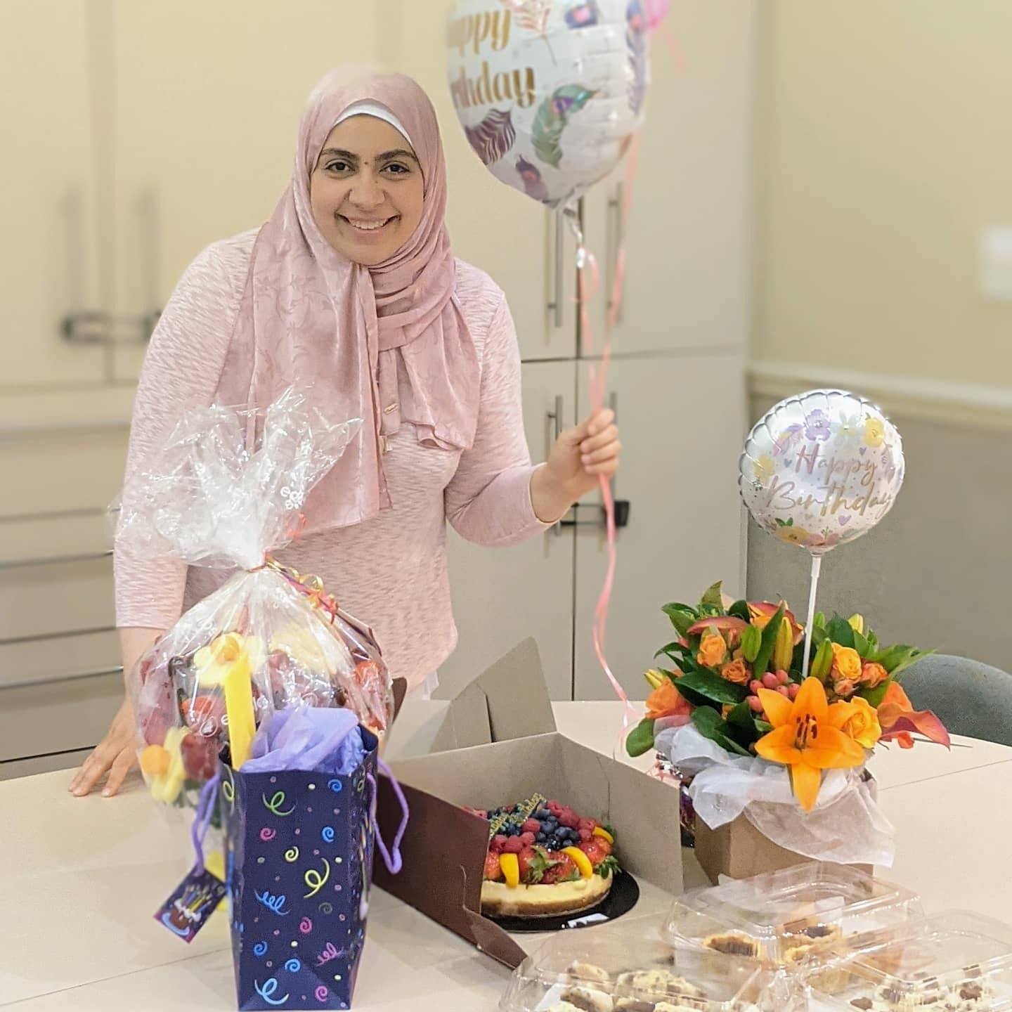 Dr. Nermeen El Gamma is holding a balloon that says happy birthday