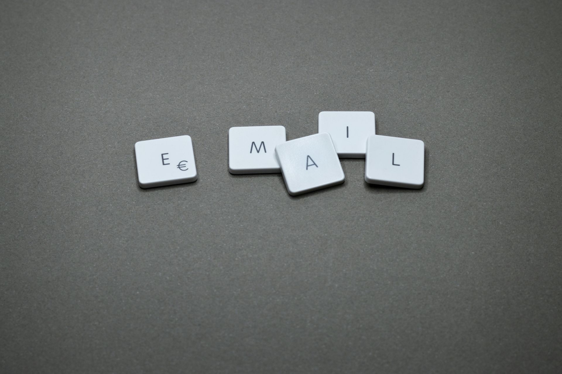 The letters e , g , m , a , and l are written on a keyboard.