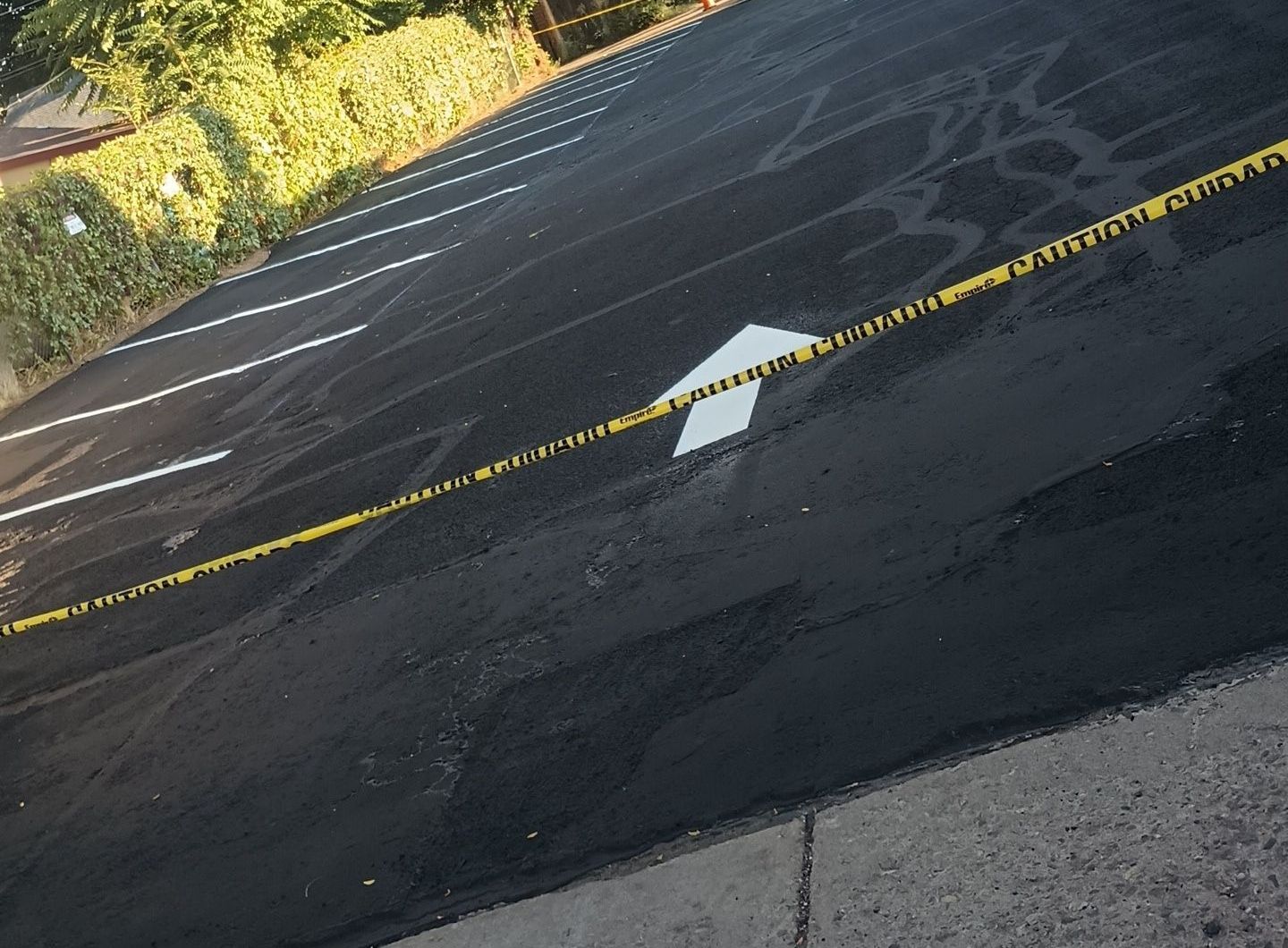 A white arrow is painted on the side of a road