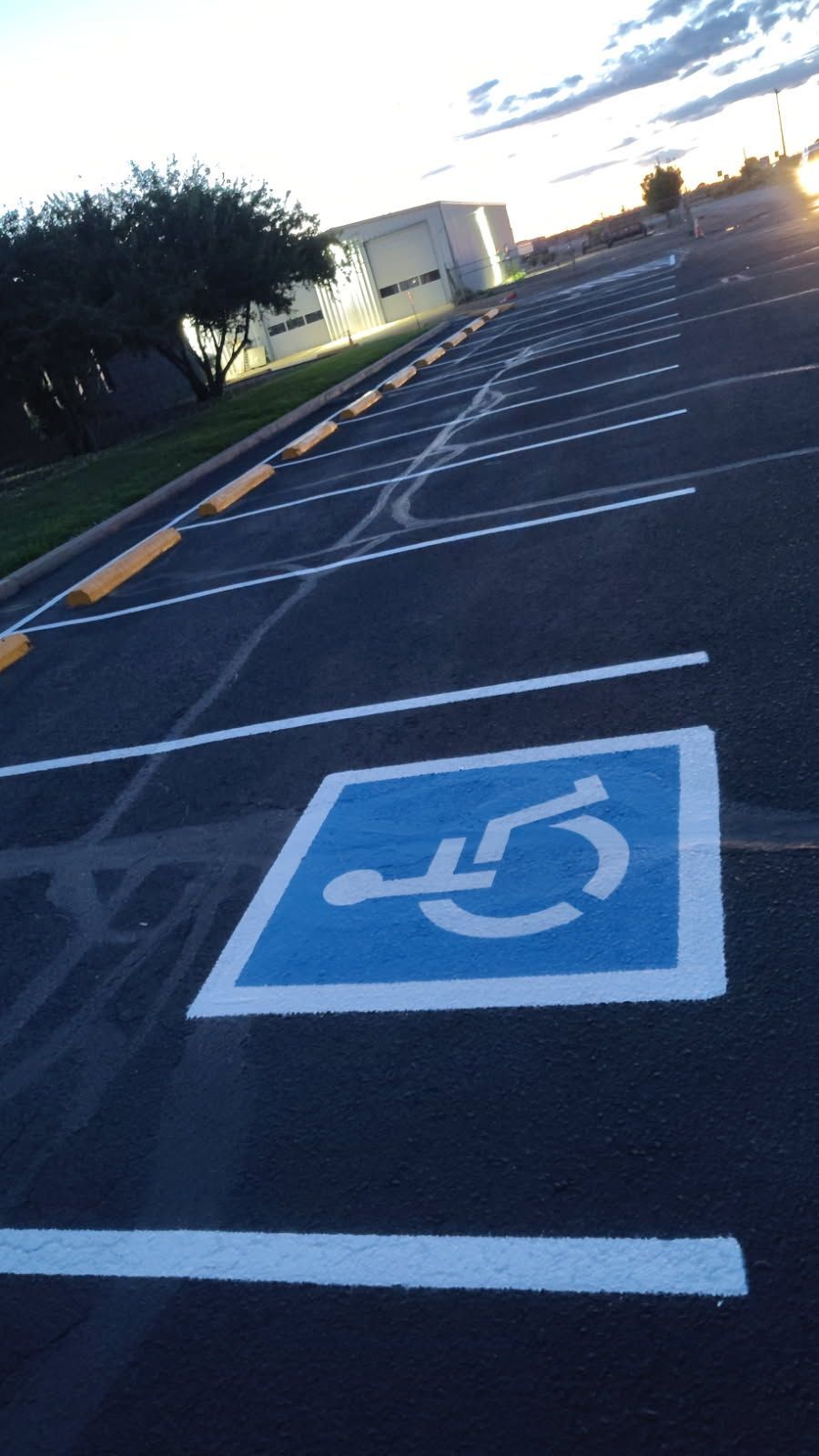 A parking lot with yellow lines painted on it.