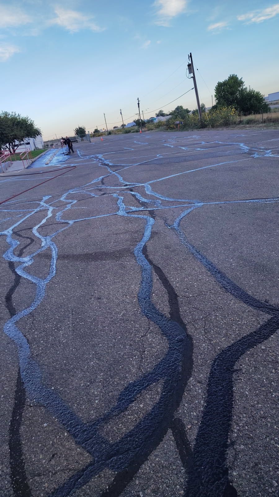 A parking lot with a yellow and white tape on it.