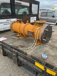 Yellow industrial heat exchanger on a trailer, parked outdoors.