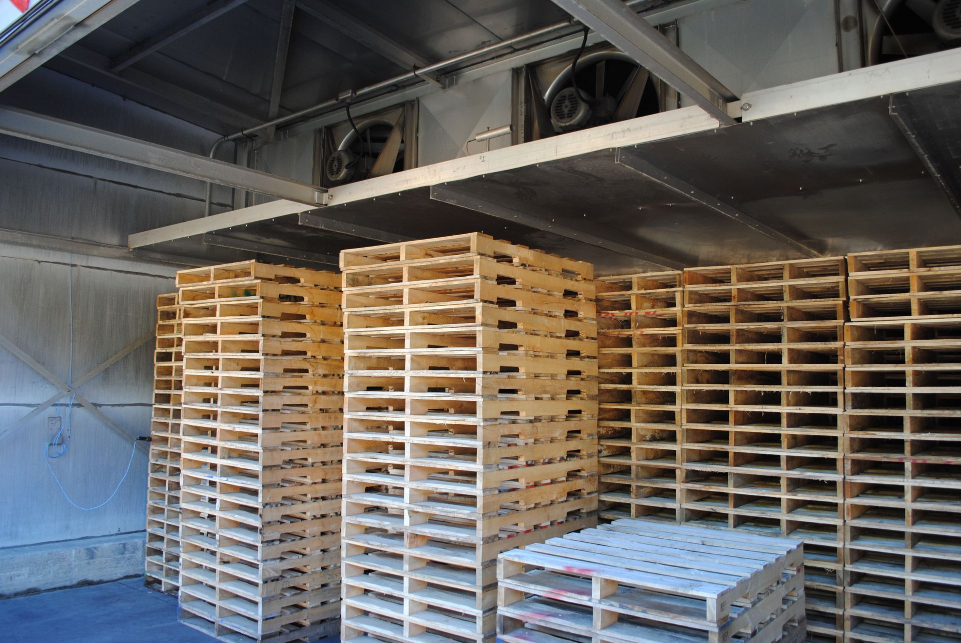 a warehouse filled with lots of wooden pallets