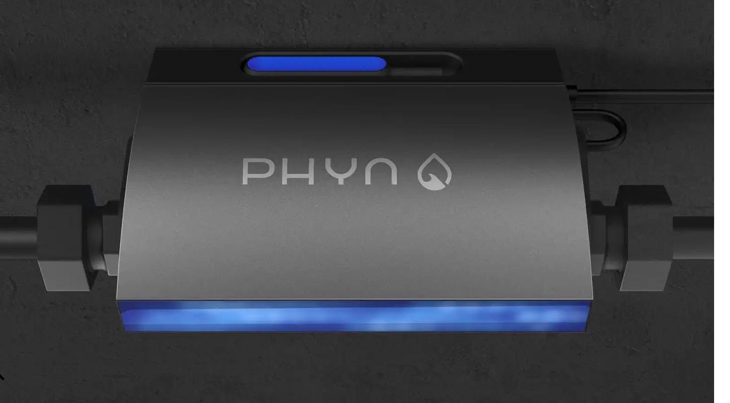 Water pouring from a chrome faucet into a dark sink.