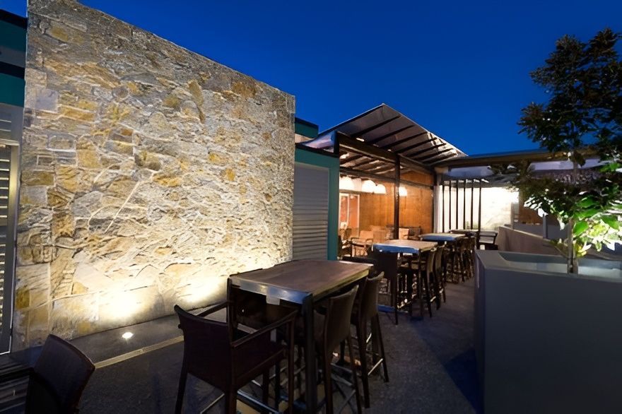 Outdoor Bar Area at Dusk With Stone Wall — Darren Gray Cad Services In Upper Corindi, NSW