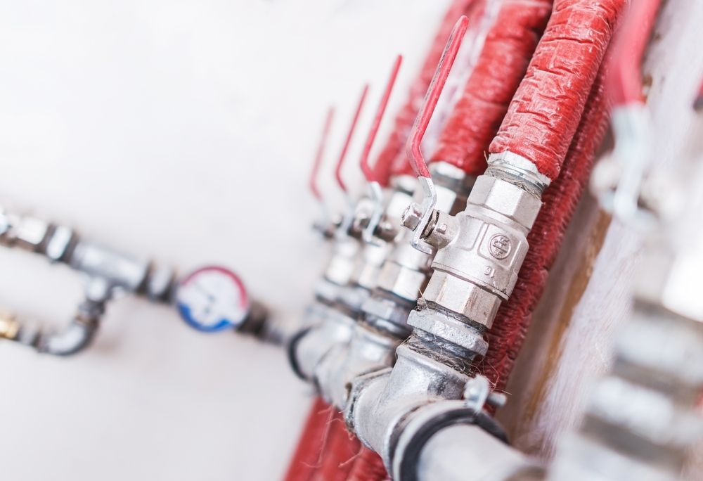 Close-up of Red Insulated Pipes — Darren Gray Cad Services In Upper Corindi, NSW