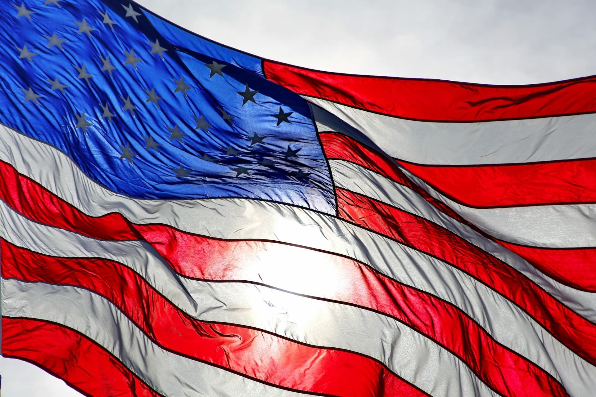 A close up of an american flag waving in the wind