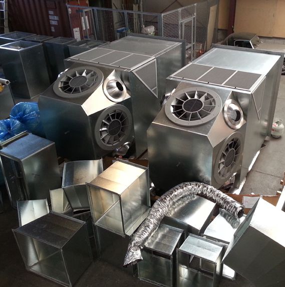 Several rectangular metal HVAC units with ductwork