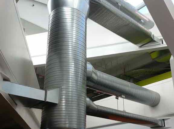 Silver HVAC ductwork in a modern building, running horizontally and vertically.