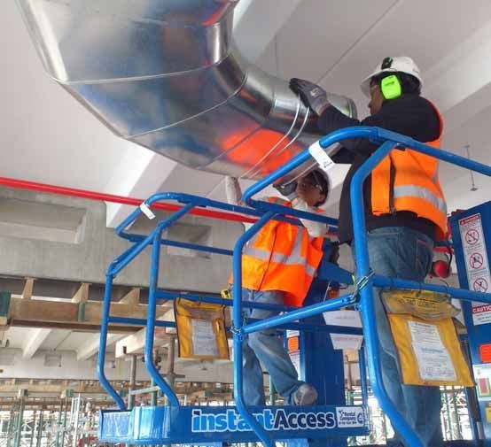 Skilled HVAC ducting installers at work