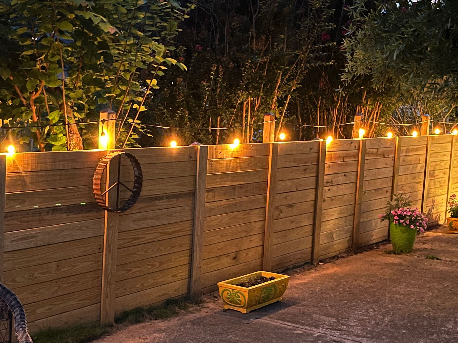A wooden fence with lights on it at night  | Louisville, KY | Lancaster Fencing