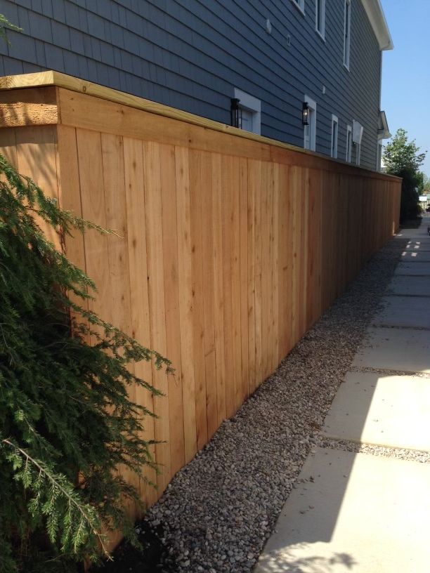 A wooden fence along a sidewalk next to a house  | Louisville, KY | Lancaster Fencing