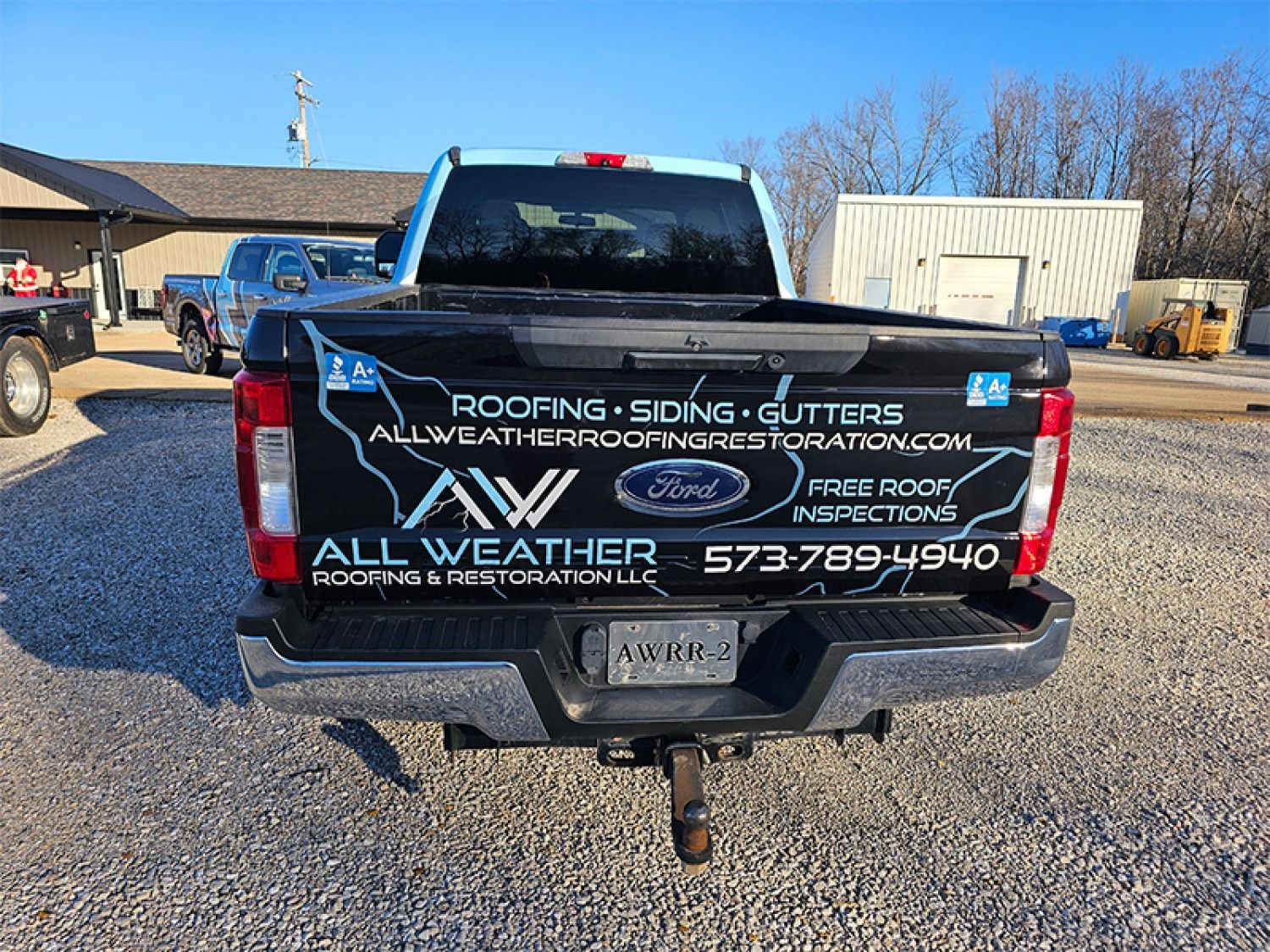 Black truck with All Weather Roofing logo and contact info. Outdoors.