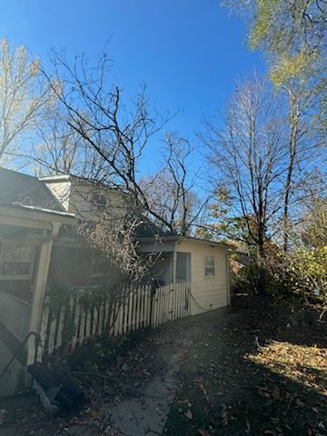 A tree has fallen on the roof of a house.