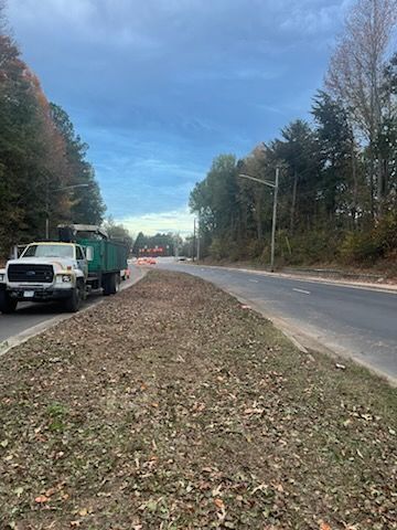 A dump truck is parked on the side of a road.