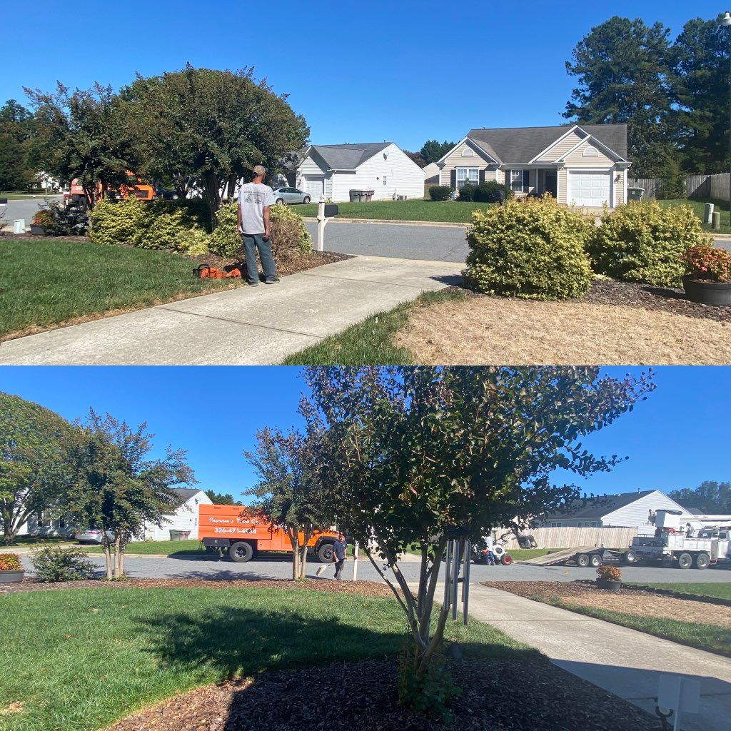 A man is standing on the sidewalk in front of a house.