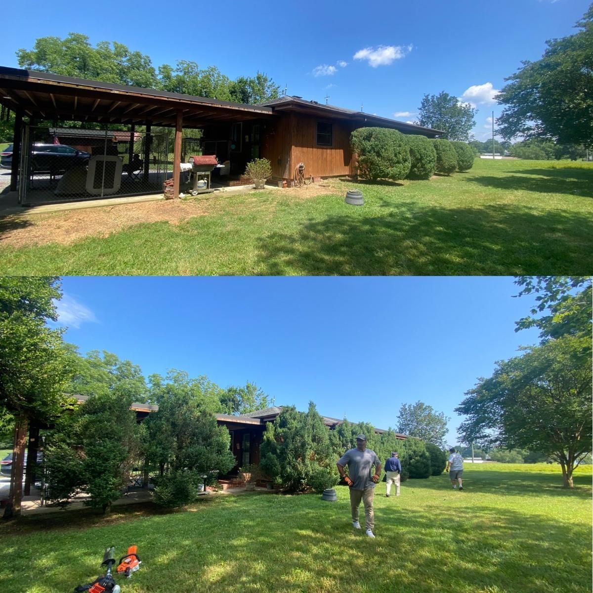 A man is standing in the grass in front of a house.