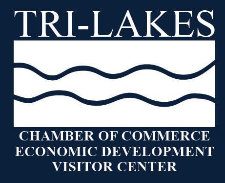 Logo for Tri-Lakes Chamber of Commerce: white text, waves, and box on dark blue background.
