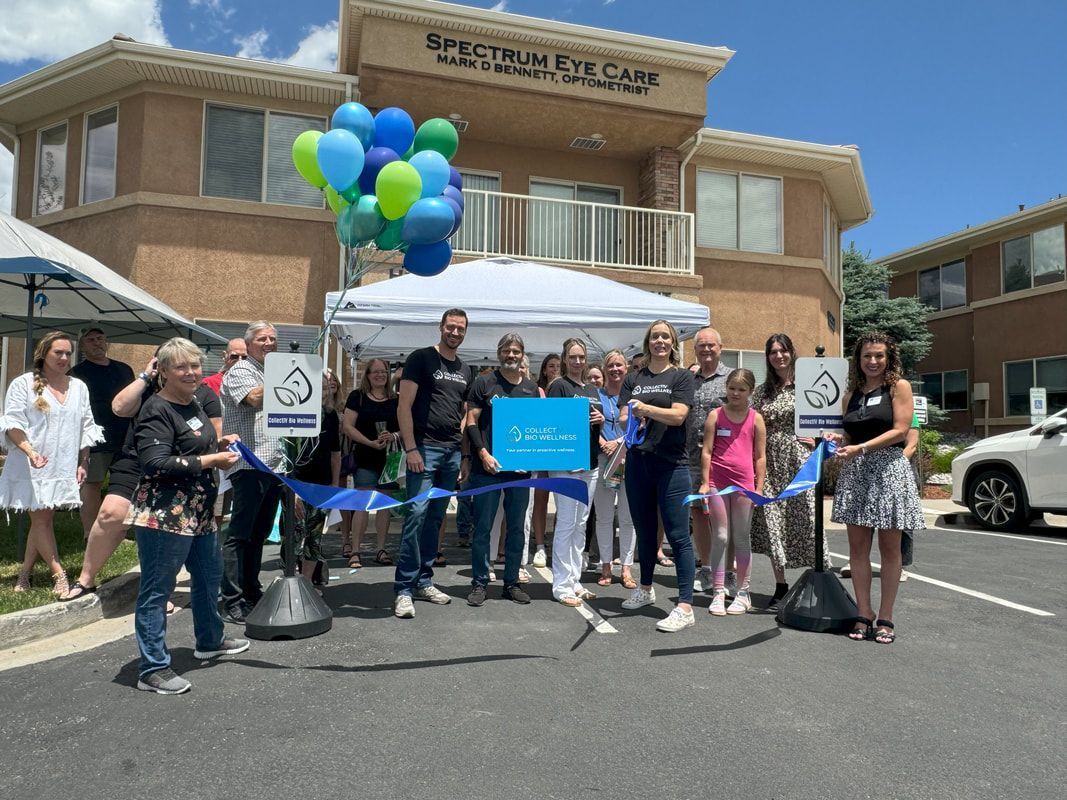 People cutting a ribbon outside a building, a grand opening. Balloons, blue accents.