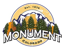 Monument, Colorado town seal: mountain scene with rock formations, evergreen trees, and town name.