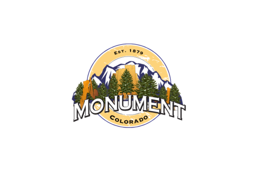 Logo for Monument, Colorado, with mountains, trees, and text in a circular design.