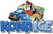 Kona Ice truck with penguin mascot, blue vehicle, serving shaved ice.