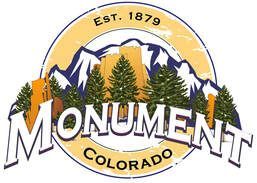 Monument, Colorado town logo: mountains, pine trees, town name, and year established.