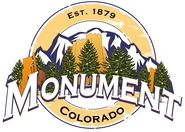 Monument, Colorado logo with mountains, trees, and town name, set against a yellow background.