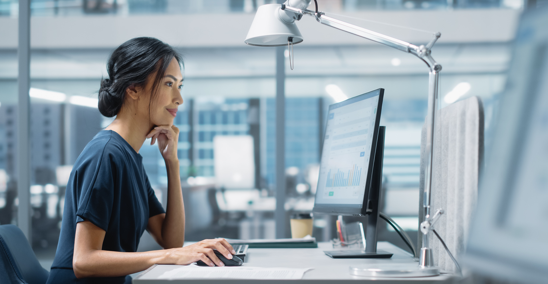 A woman browsing her computer for managed IT solutions.