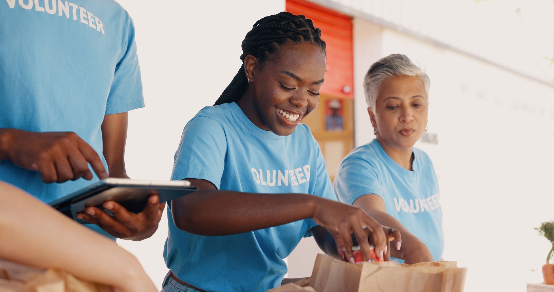 A group of volunteers are standing around a table.