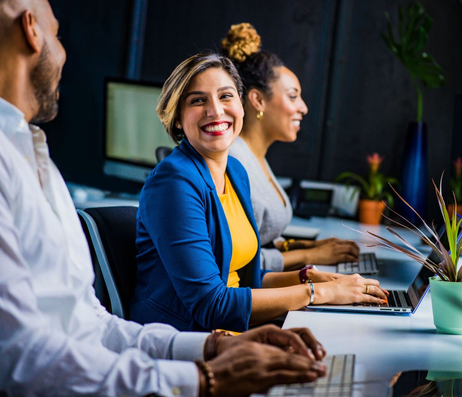 A woman and her colleagues excited to support a small business through IT consulting. 