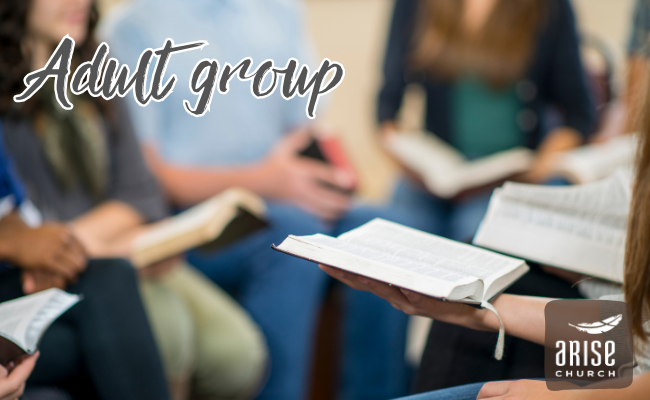 A group of people are sitting in a circle reading books.