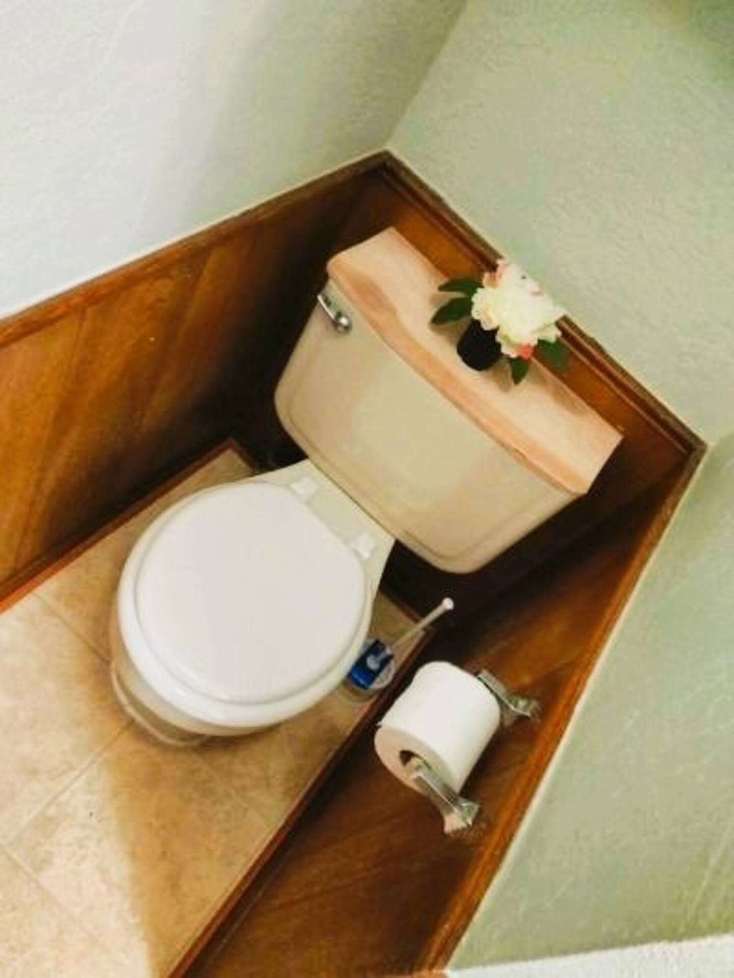 A toilet with a flower on top of it