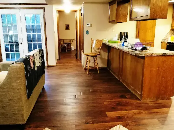 A living room with a couch and a kitchen