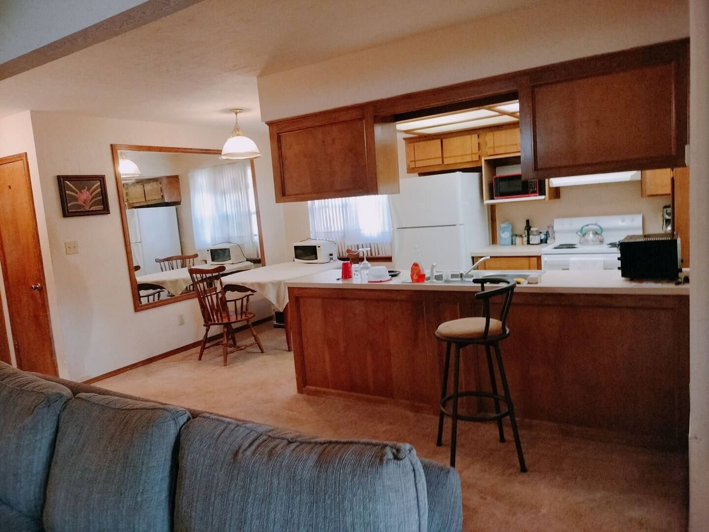 A living room with a couch and a kitchen