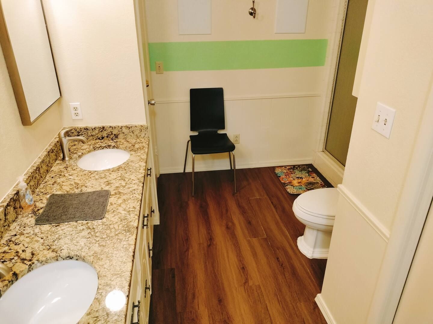 A bathroom with two sinks and a toilet