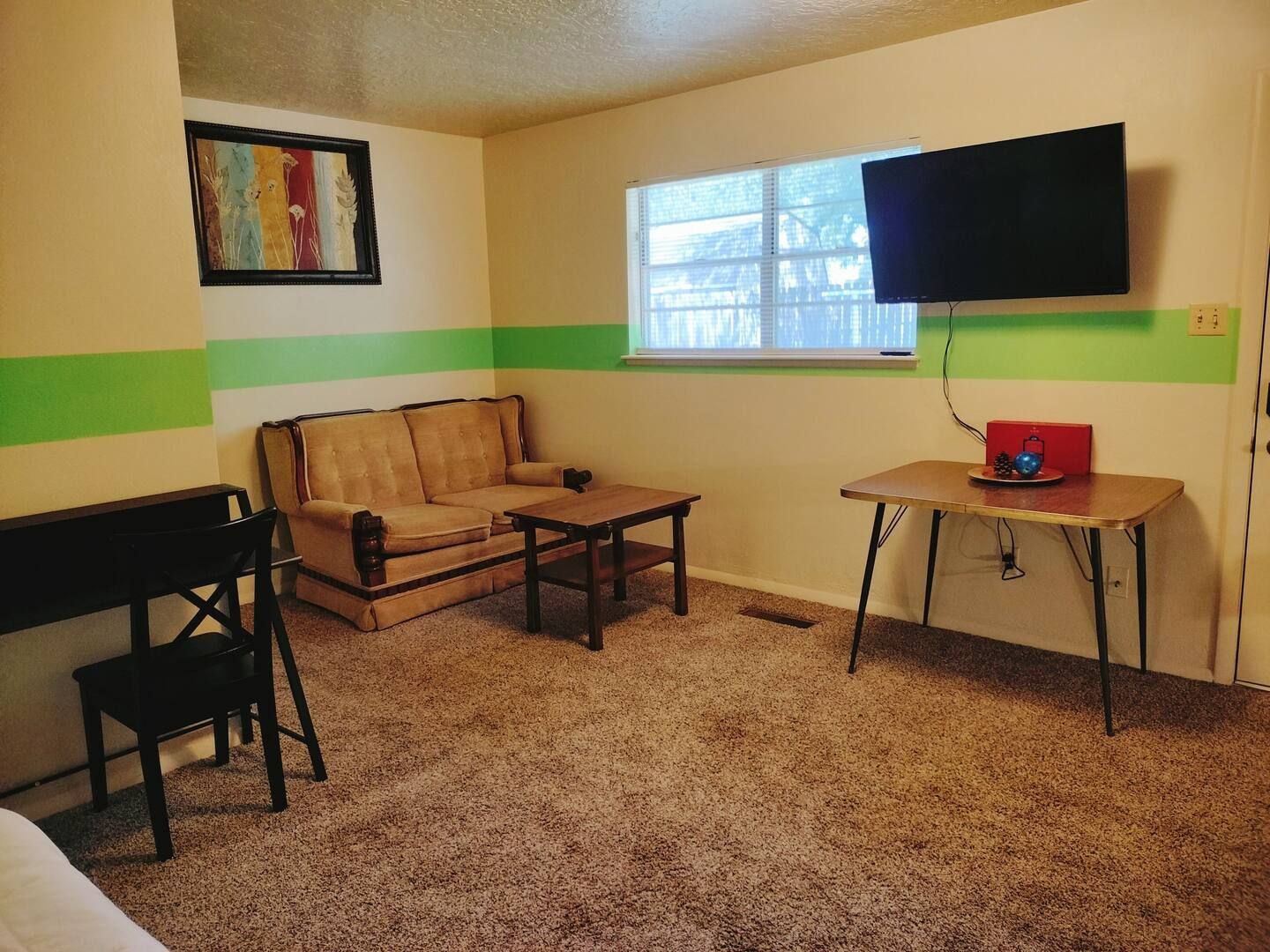 A living room with a couch a table and a flat screen tv