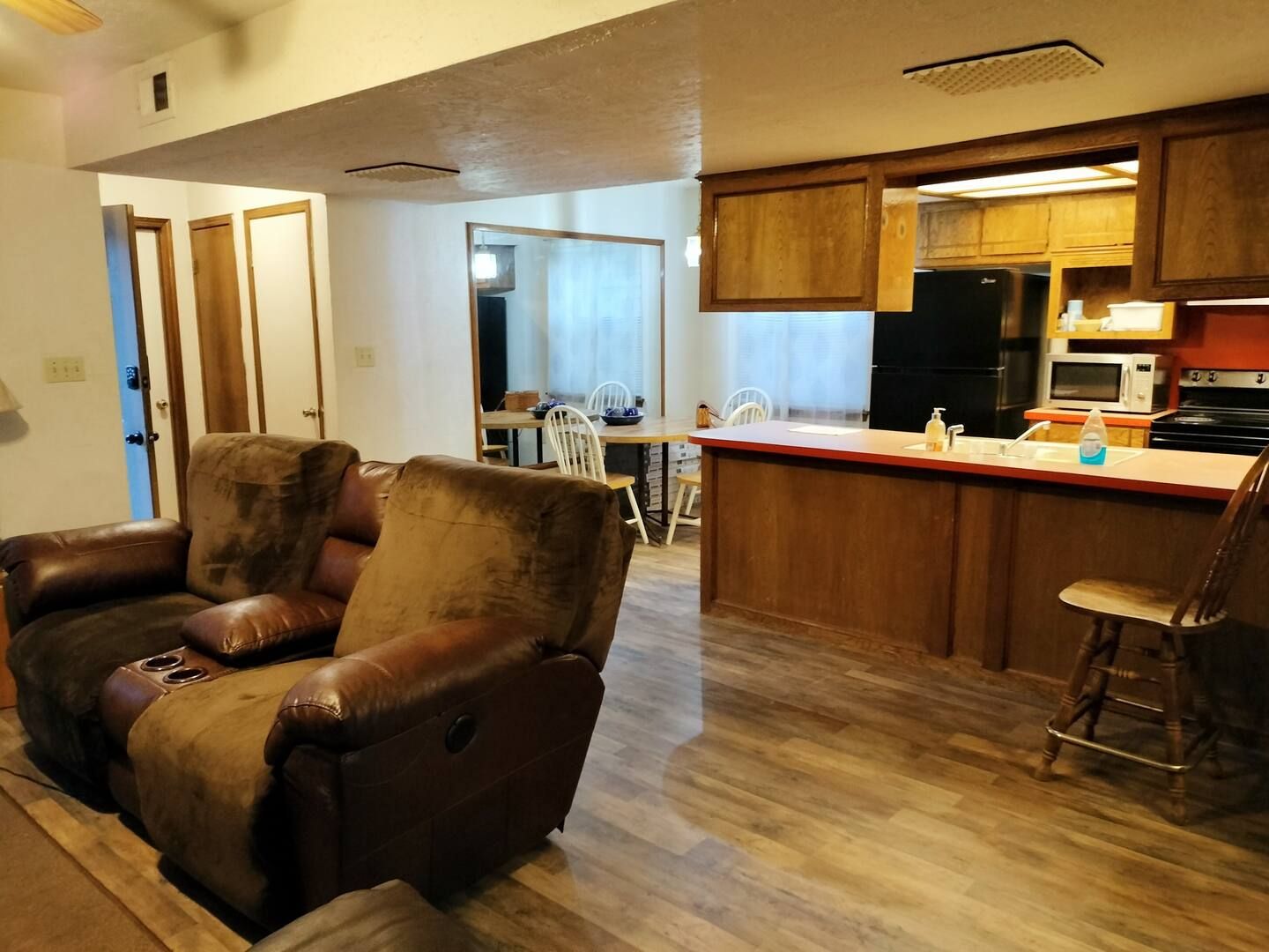 A living room with a recliner and a chair