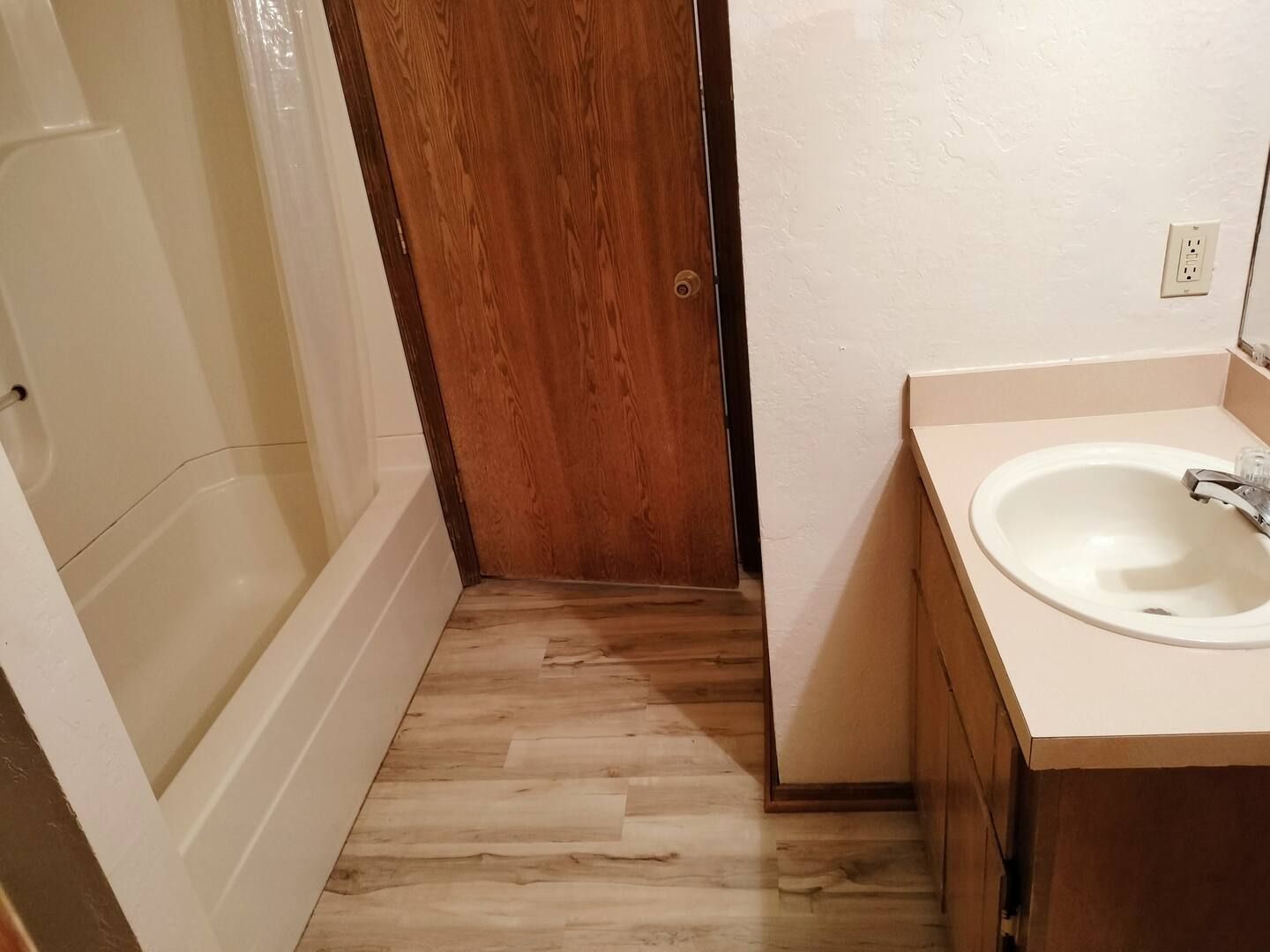 A bathroom with a sink and a shower.