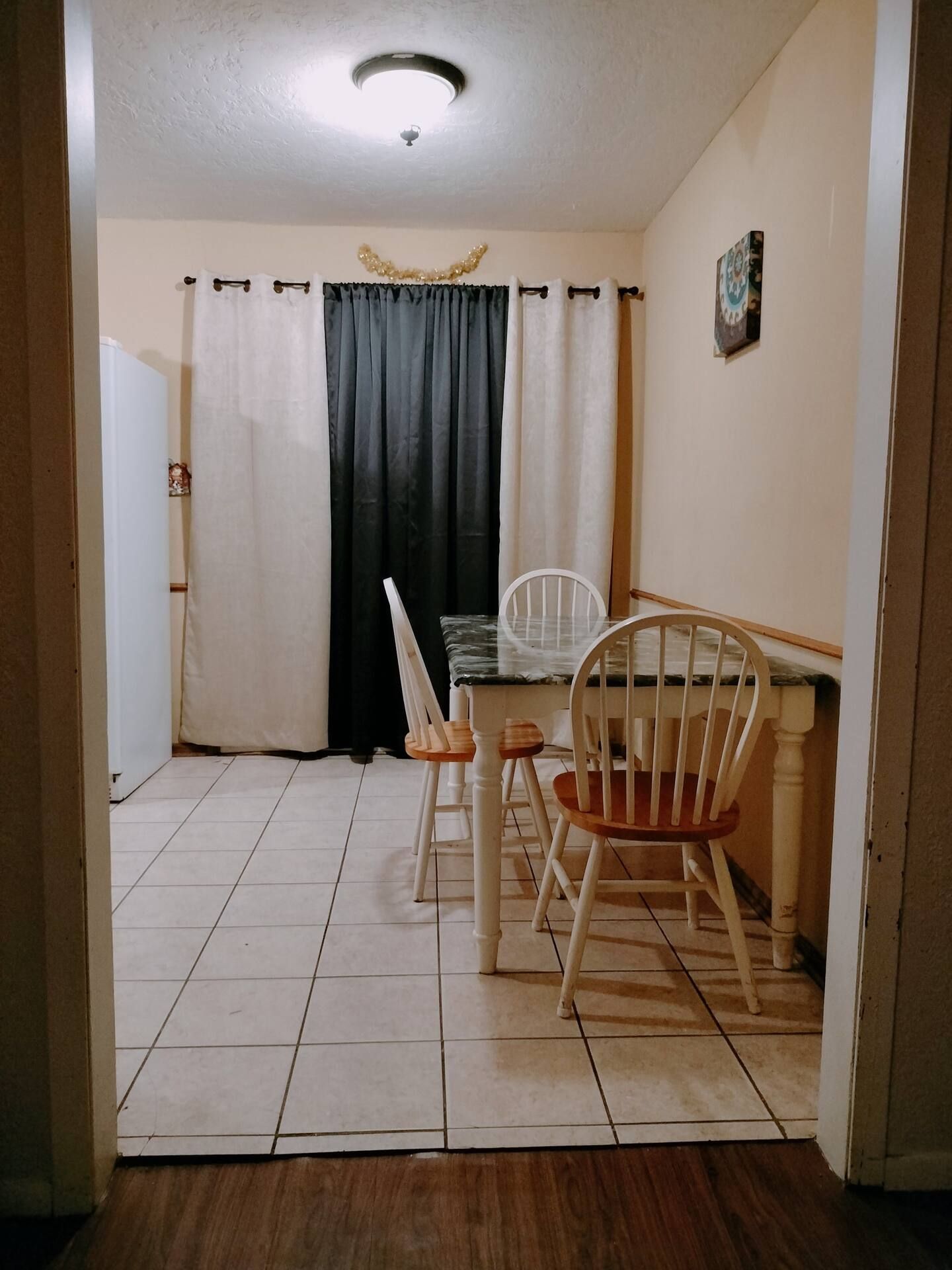A kitchen with a table and chairs in it