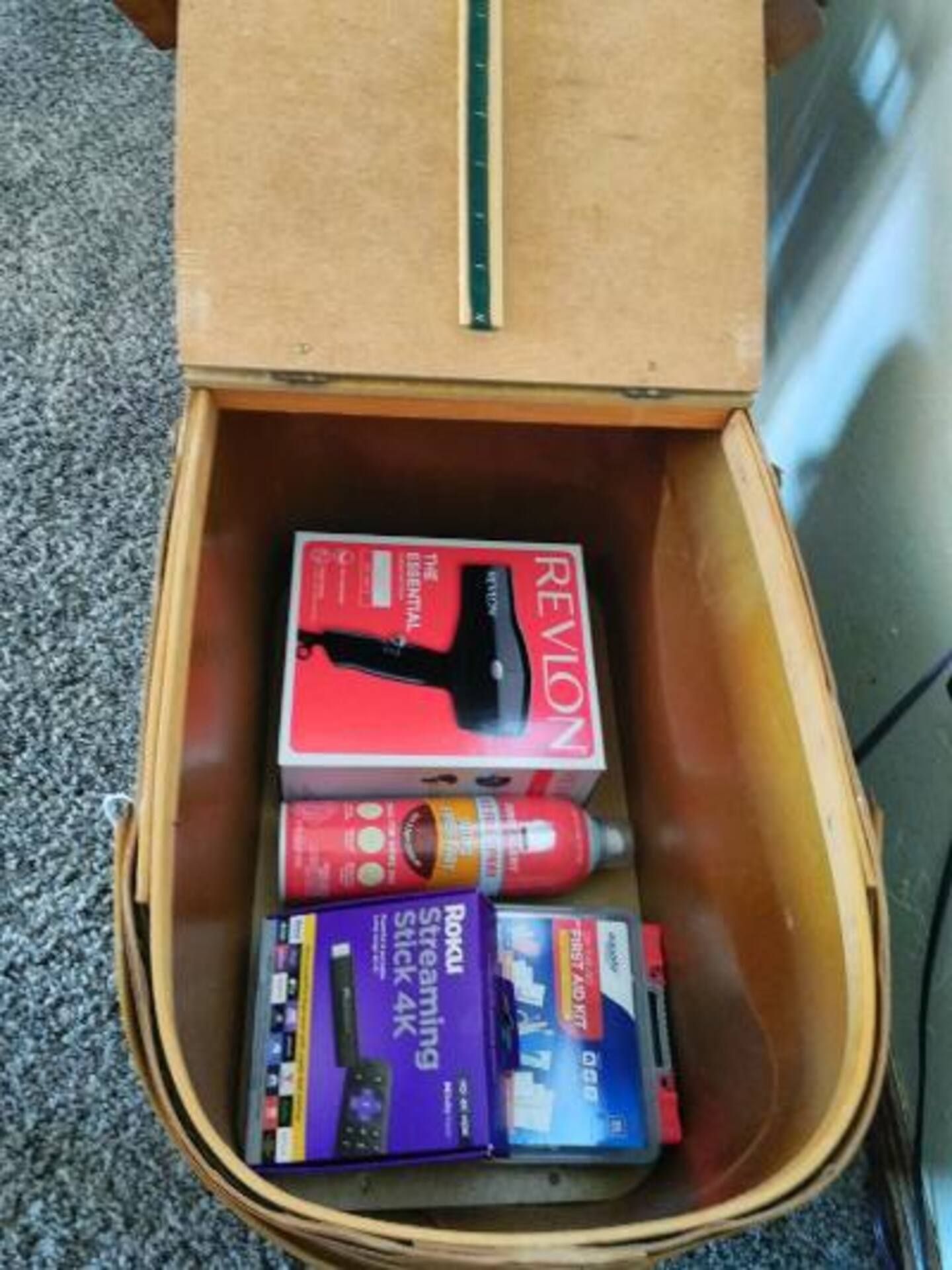 A box of revlon hair dryer sits in a basket